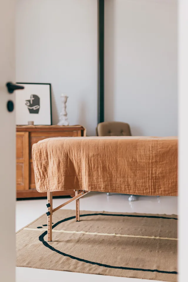 Massage table with a linen cover in the treatment room