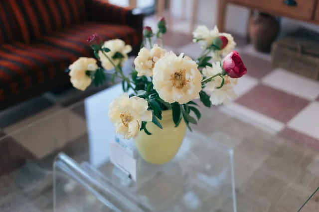 Fresh flowers on a glass table in the café at Stretch & Fold